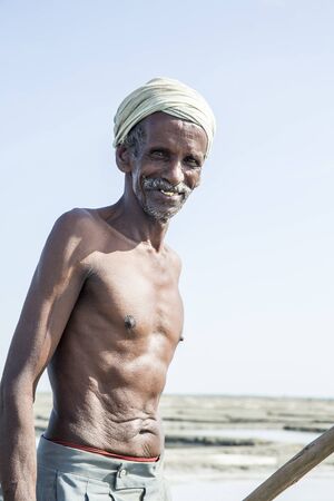 Documentary image editorial. Pondicherry, Tamil Nadu, India - July 05 2014. Poor workers picking up,...