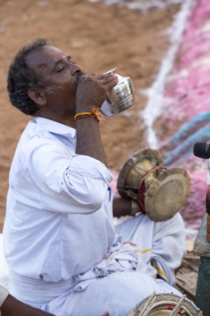 Pondicherry, Tamil Nadu,India - May 15, 2014 : each year in villages, people celebrate the temple fest, for the full day. They walk in groups, they launch paint on people, play music.のeditorial素材