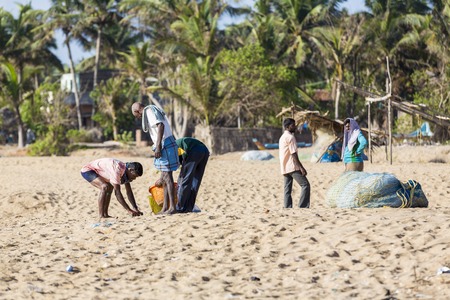 Pondichery, Tamil Nadu, India - February 27, 2014 : Traditional fishermen on beach, on sea, on sand. Long boats, Hard work poor peopleのeditorial素材