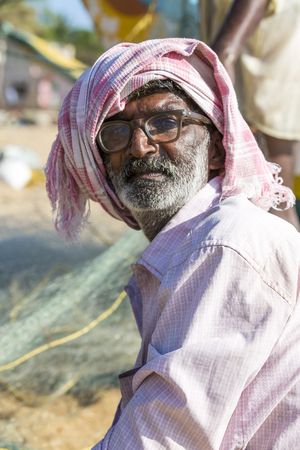 Pondichery, Tamil Nadu, India - February 27, 2014 : Traditional fishermen on beach, on sea, on sand. Long boats, Hard work poor peopleのeditorial素材