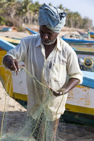 Pondichery, Tamil Nadu, India - February 27, 2014 : Traditional fishermen on beach, on sea, on sand. Long boats, Hard work poor peopleのeditorial素材