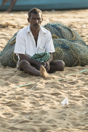 Pondichery, Tamil Nadu, India - February 27, 2014 : Traditional fishermen on beach, on sea, on sand. Long boats, Hard work poor peopleのeditorial素材