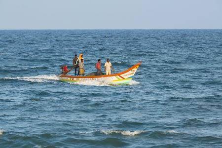 Pondichery, Tamil Nadu, India - February 27, 2014 : Traditional fishermen on beach, on sea, on sand. Long boats, Hard work poor peopleのeditorial素材