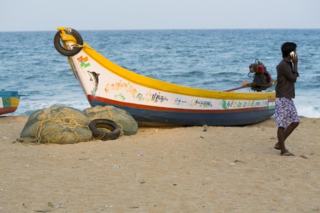 Pondichery, Tamil Nadu, India - February 27, 2014 : Traditional fishermen on beach, on sea, on sand. Long boats, Hard work poor peopleのeditorial素材
