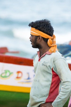 Pondichery, Tamil Nadu, India - February 27, 2014 : Traditional fishermen on beach, on sea, on sand. Long boats, Hard work poor peopleのeditorial素材
