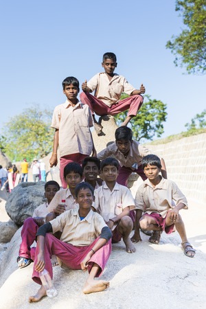 Pondichery, Tamil Nadu, India - February 23, 2014. Group of school boys and girls with uniforms in park, walking or sitting.のeditorial素材
