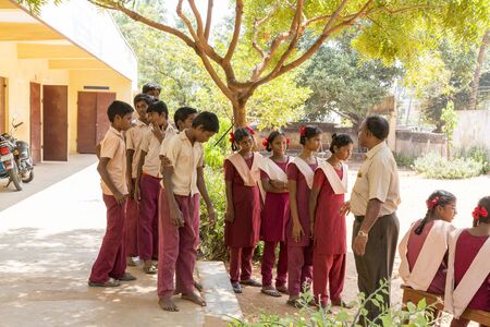 Pondichery, Tamil Nadu, India - March 03, 2014. In the school, teachers preparing the shooting photo of the students. Children very excited of this moment.のeditorial素材