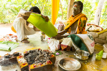 Documentary image. Pondichery, Tamil Nadu, India. May 27, 2014. Puja Thila homa with french lady and priest, brahman to pray about died man.のeditorial素材