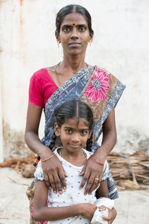 Illustrative image. Pondichery, Tamil Nadu, India. April 14, 2014. Child with mother in the street of villageのeditorial素材