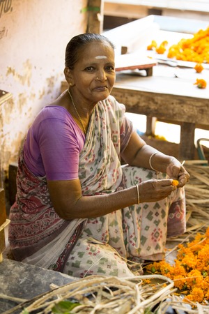 Illustrative image. Pondichery, Tamil Nadu, India - May 14, 2014. Main market of flowers, men and women workingのeditorial素材