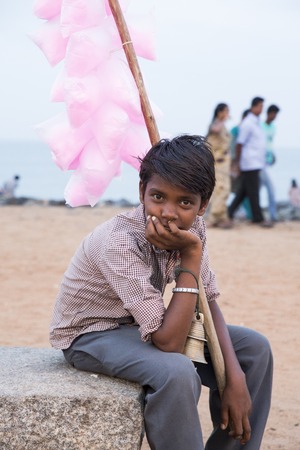 Illustrative image. Pondicherry, Tamil Nadu, India - February 25, 2014. Adolescents, young people in the street, eating shopping selling playingのeditorial素材