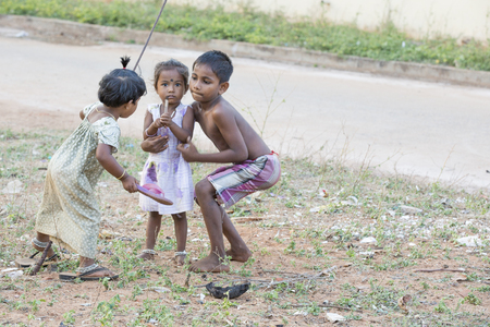 Illustrative image. Pondicherry, Tamil Nadu, India - Marsh 13, 2014. Poor children boys and girls in the street of small villagesのeditorial素材