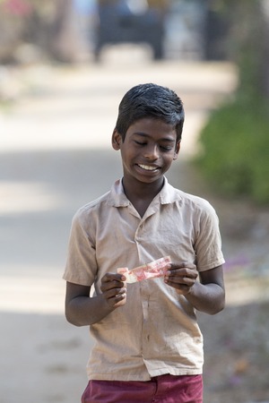 Illustrative image. Pondicherry, Tamil Nadu, India - Marsh 07, 2014. Poor child with smile feeling, in the streetのeditorial素材