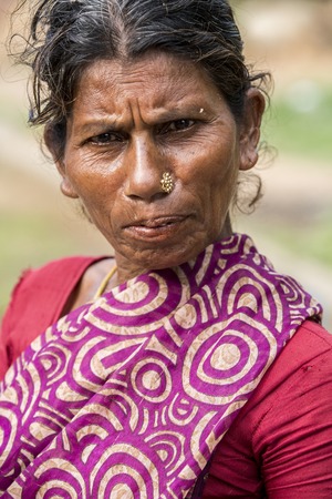 Illustrative image. Pondicherry, Tamil Nadu, India - April 14, 2014. Portrait of senior indian woman in traditional costume. Poor women sad smiling sittingのeditorial素材