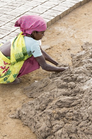 Illustrative image. Pondicherry, Tamil Nadu, India - July 03, 2014. Poor woman worker in small village, very hard work for little money roupiesのeditorial素材
