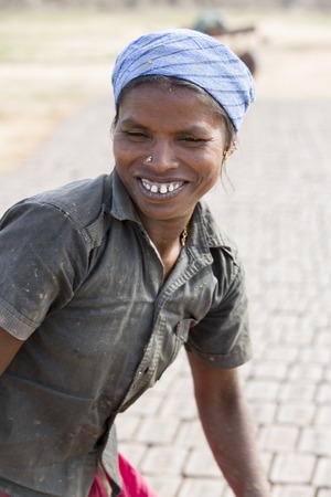 Illustrative image. Pondicherry, Tamil Nadu, India - July 03, 2014. Poor woman worker in small village, very hard work for little money roupiesのeditorial素材