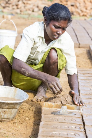 Illustrative image. Pondicherry, Tamil Nadu, India - July 03, 2014. Poor woman worker in small village, very hard work for little money roupiesのeditorial素材