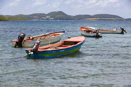 La Trinit , Martinique - April 10, 2017. Colored wood boats floating on the Caraibe sea.のeditorial素材