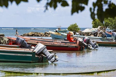 La Trinit , Martinique - April 10, 2017. Colored wood boats floating on the Caraibe sea.のeditorial素材