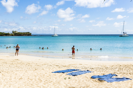 Les salines, Martinique - April 8, 2017. Tropical beach with with sand and blue sea, with people in and near the water.のeditorial素材
