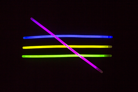 Glow sticks neon light fluorescent on back background. variation of different colored chem lightsの写真素材