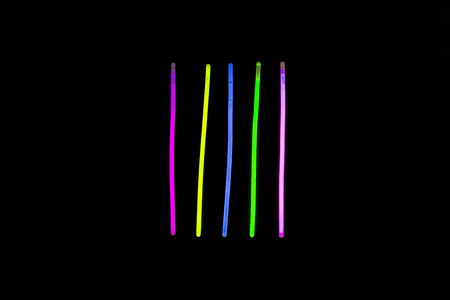 Glow sticks neon light fluorescent on back background. variation of different colored chem lightsの写真素材