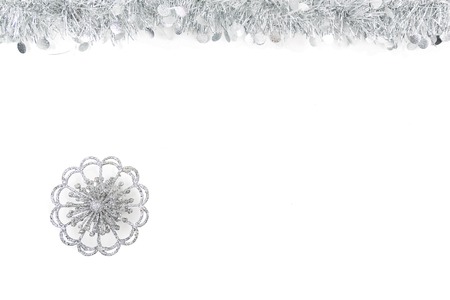Christmas Garland with silver star on white Background. Top View of Xmas Decoration Close-Up with Text Spaceの写真素材