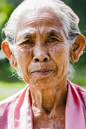Ubud, Indonesia - July 28, 2013. An unidentified Balinese rice very old farmer poses during a morning's work near Ubud,のeditorial素材