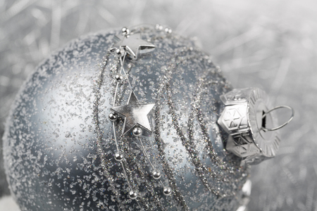 silver christmas ornament decorated ball on white background.の写真素材