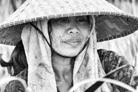 Ubud, Bali, Indonesia - August 01, 2013. An unidentified Balinese rice farmer poses during a morning's work. black and white picture