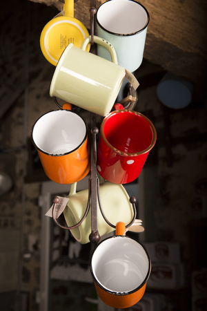 Valognes, Normandy, France - February 06, 2014. Traditional typical delicatessen shop in Normandy. close up of retro mugs to drink coffee, tea, beerのeditorial素材