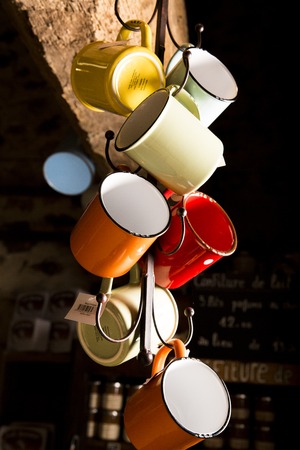 Valognes, Normandy, France - February 06, 2014. Traditional typical delicatessen shop in Normandy. close up of retro mugs to drink coffee, tea, beerのeditorial素材