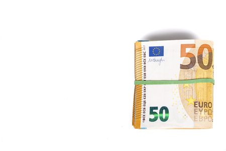 Wad of euro bills banknotes cash on table.の写真素材