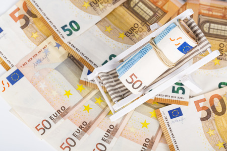 Rolled Up Bundle Of Fifty euro Banknotes bills, On Miniature Deck Chair sun lounger. Concpet of prices, costs of holiday, travel.の写真素材