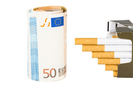 20 and 50 Euro banknotes bills cash with cigarettes, increase graph made with cigarettes. Concept of cost of tabacco, cigarettes. Front and top view, close-up.の写真素材