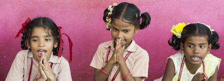 PONDICHERY, PUDUCHERY, INDIA - SEPTEMBER 04, 2017. Unidentified boys girls children get in lines with their plates to clean it before lunch at the outdoor canteen.のeditorial素材