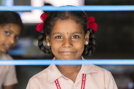 PONDICHERY, PUDUCHERY, INDIA - SEPTEMBER 04, 2017. Unidentified child at schhol behind the windowのeditorial素材