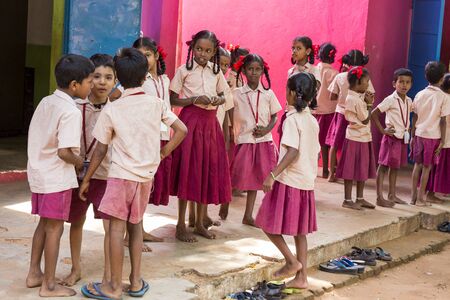 PONDICHERY, PUDUCHERY, INDIA - SEPTEMBER 04, 2017. Happy kids with school uniforms play in the school, excited to see french photographer in their school.のeditorial素材