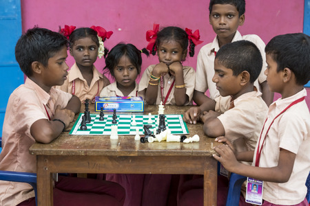 PONDICHERY, PUDUCHERY, INDIA - SEPTEMBER 04, 2017. Indian children playing chess at the table. at school the concept of childhood and board games, brain development and logicのeditorial素材
