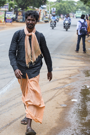 Photo for PONDICHERY, PUDUCHERY, INDIA - AUGUST 28, 2017. Unidentified christians, catholics, hinduists people, with orange dress, pilgrims walk from chennai to Velanganni, for annual pilgrimage at the church of Velankanni. They walk more than 250 kilometers. - Royalty Free Image