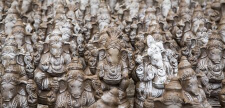 Many hand crafted Ganesha idol clay statues displayed in the market during Ganesh Festival.の写真素材