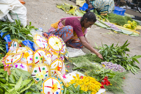 PONDICHERY, PUDUCHERY, INDIA - SEPTEMBER 09, 2017. Unidentified man woman at his outdoor shop to sell umbrella in the main market of the city, in south of India, Asia.のeditorial素材