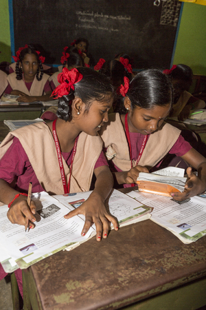 PONDICHERY, PUDUCHERY, INDIA - STEPEMBER 04, 2017. Unidentified children boys girls with school uniform, study in classroom, with books. Government public school.のeditorial素材