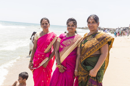 MASI MAGAM FESTIVAL, PUDUCHERY, PONDICHERY, TAMIL NADU, INDIA - March 1, 2018. Group of unidentified Indian pilgrims women men bathing in the sea, on the beachのeditorial素材
