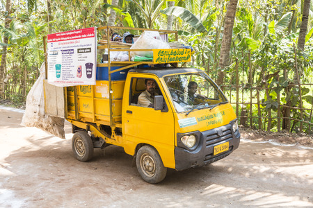 PUDUCHERY, PONDICHERY, TAMIL NADU, INDIA - March circa, 2018. Small yellow garbage truck with...