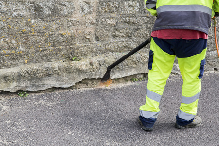 Man burn weeds with torch, thermal weeds control. Environmental protectionの写真素材