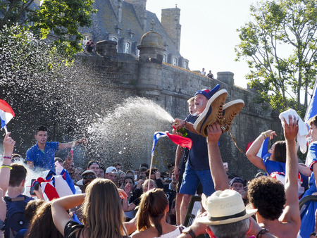 ST MALO, FRANCE - JULY 15, 2018. Unidentified French football fans supporters after the match of FIFA World Cup Russia 2018 France vs Croatia. France won 4-2. French are the world champion. People in smoke, so happy, singing, yelling in the streetのeditorial素材