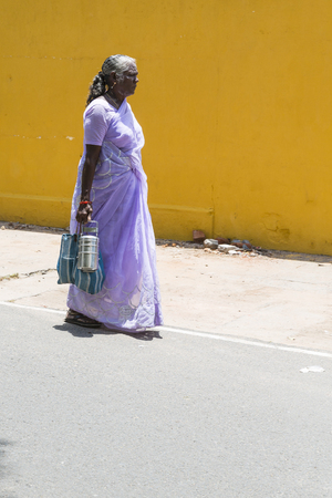 PONDICHERY, PUDUCHERRY, TAMIL NADU, INDIA - SEPTEMBER CIRCA, 2017. Unidentified poor woman in saree walking on street.のeditorial素材