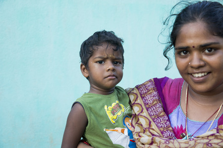 PONDICHERRY, PUDUCHERRY, TAMIL NADU, INDIA - March Circa, 2018. Unidentified poor child with mother in the street of villageのeditorial素材