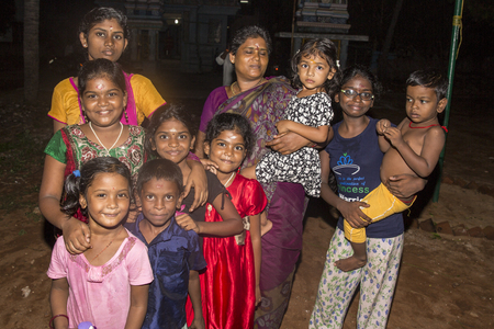 PONDICHERY, PUDUCHERRY, TAMIL NADU, INDIA - MARCH CIRCA, 2018. Unidentified happy smiling poor rural children teenagers playing at street of village Pondicheryのeditorial素材